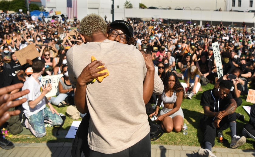 One of Breonna Taylor’s family members, right, is hugged by another woman after speaking to protesters in Beverly Hills in an undated photo. The protest was organized by the Refuse Fascism group. (Wally Skalij / Los Angeles Times)