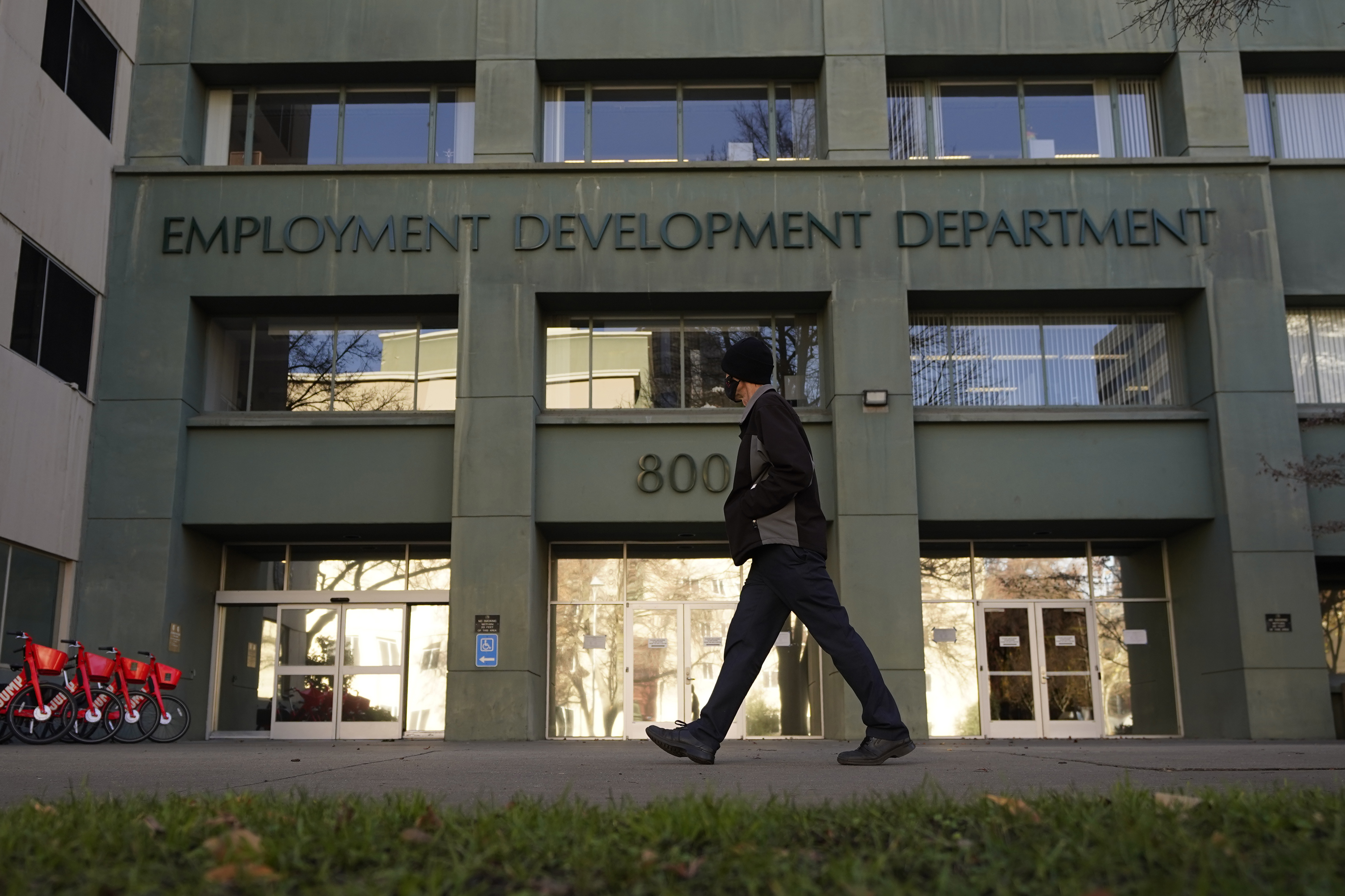 A person passes the office of the California Employment Development Department in Sacramento on Dec. 18, 2020. (Rich Pedroncelli / Associated Press)