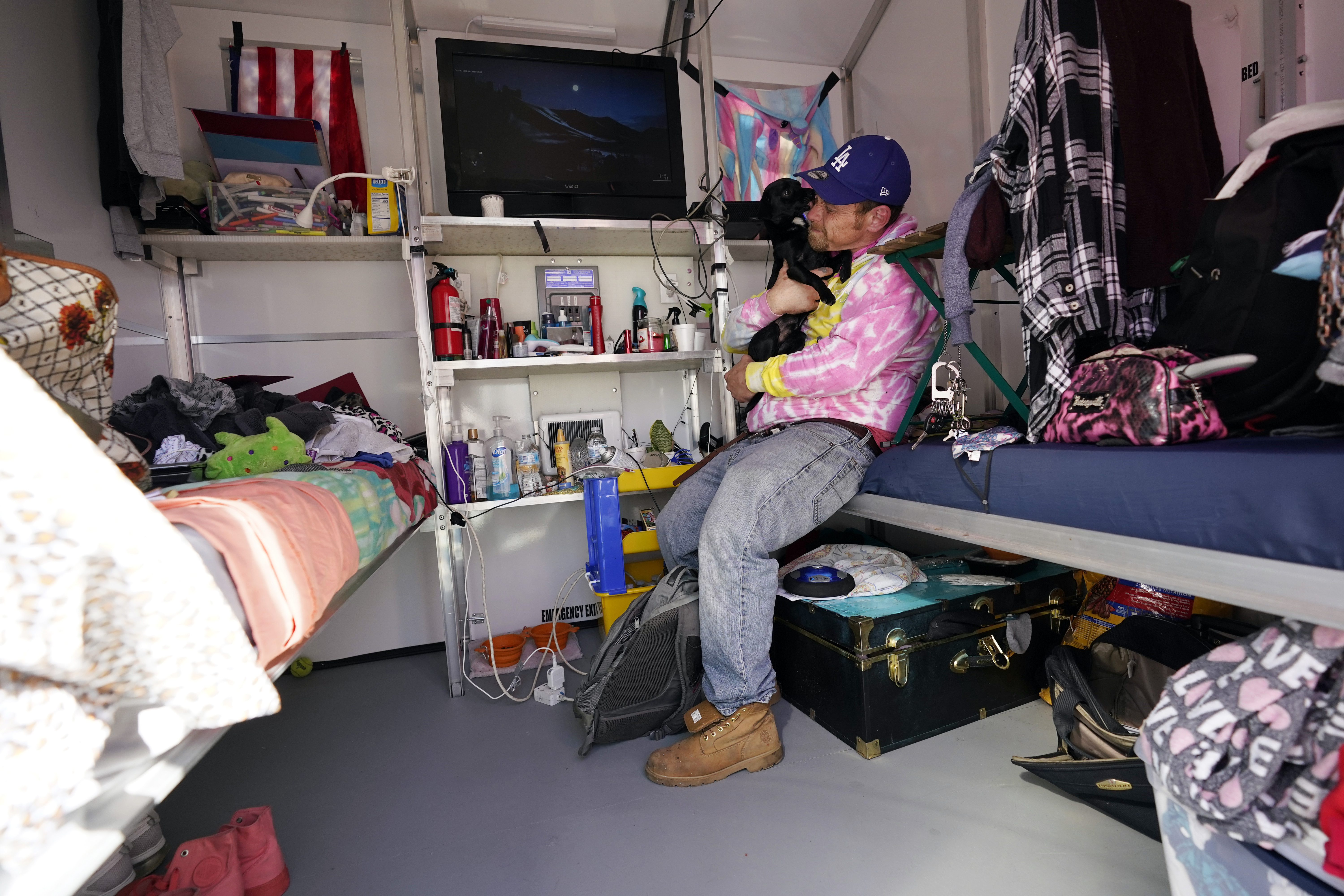 A homeless person sits inside his tiny home on Feb. 25, 2021, in North Hollywood. (AP Photo/Marcio Jose Sanchez)