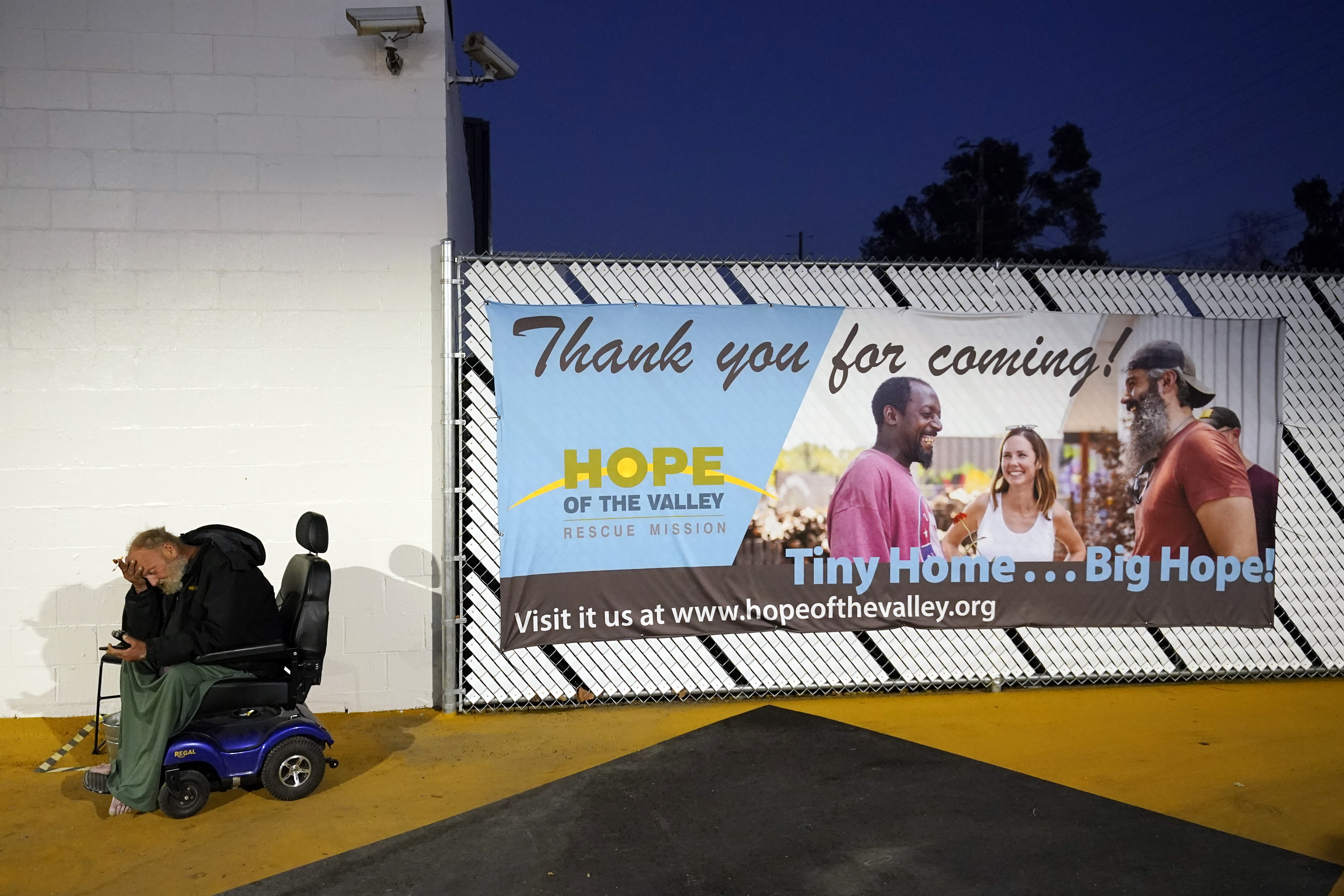 Tiffany sits in a courtyard area in a tiny homes community for the homeless on Feb. 25, 2021, in North Hollywood. (AP Photo/Marcio Jose Sanchez)