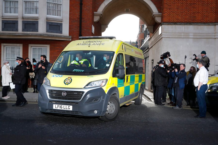 Police officers stand at an entrance to the King Edward VII Hospital where Prince Philip is being treated for an infection, as an ambulance is driven out, in London, Monday, March 1, 2021. (AP Photo/Frank Augstein)