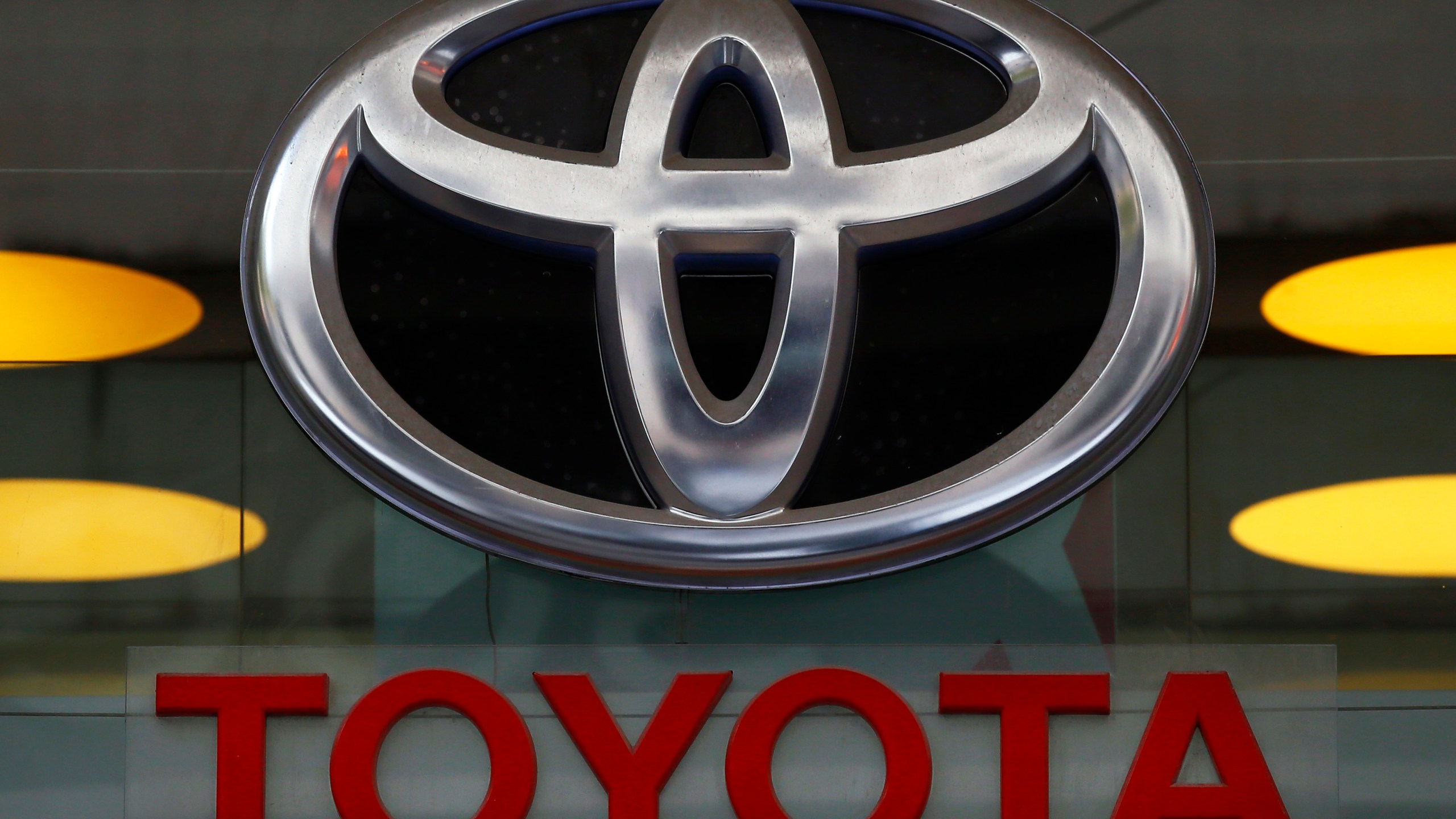 In this Sept. 20, 2017, file photo the Toyota logo is displayed at their shop on the Champs Elysees Avenue in Paris. The U.S. government is investigating complaints of engine compartment fires in nearly 1.9 million Toyota RAV4 small SUVs. The National Highway Traffic Safety Administration began investigating after getting 11 fire complaints involving the 2013 through 2018 model years. (AP Photo/Francois Mori, File)