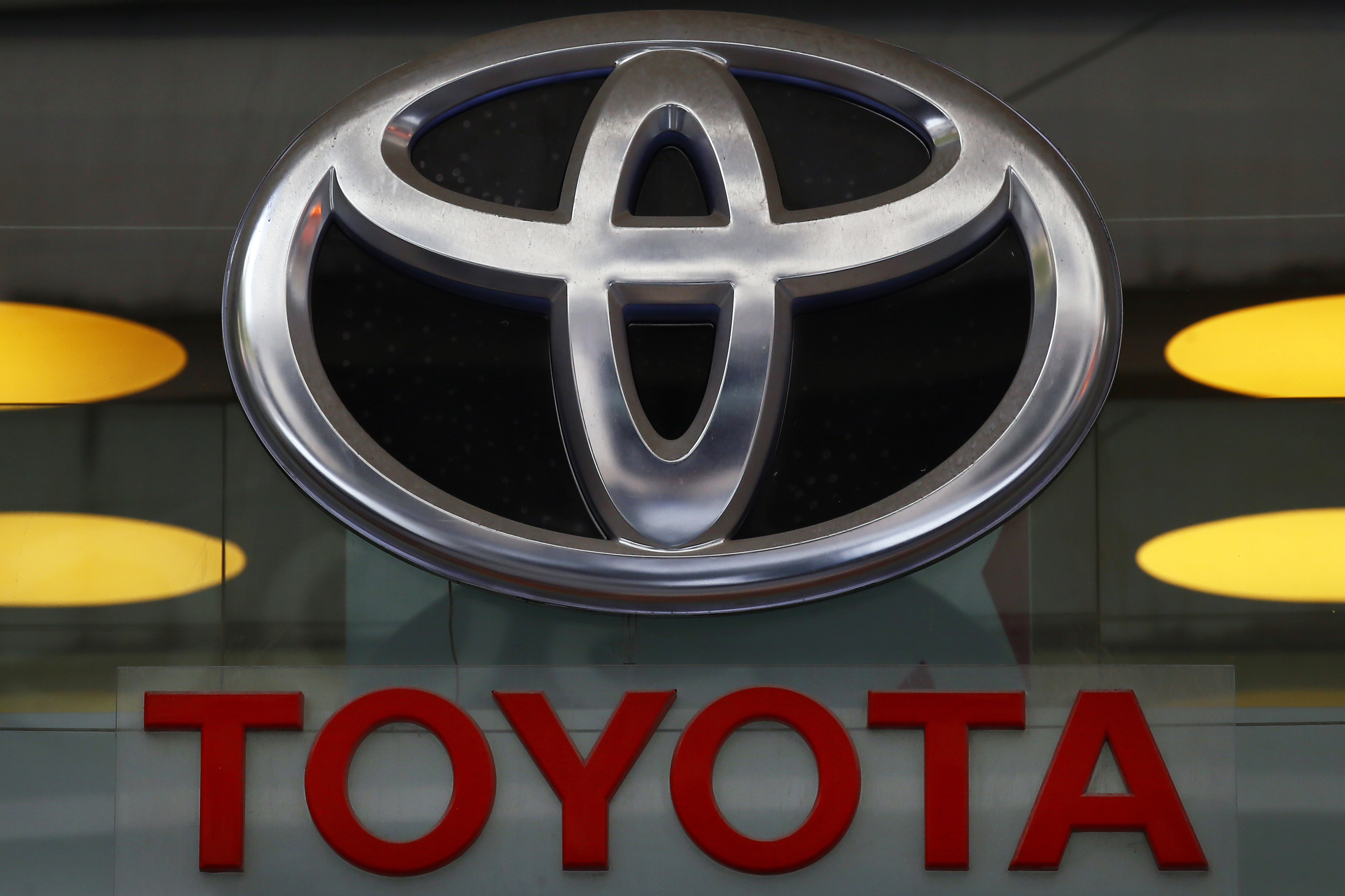 In this Sept. 20, 2017, file photo the Toyota logo is displayed at their shop on the Champs Elysees Avenue in Paris. The U.S. government is investigating complaints of engine compartment fires in nearly 1.9 million Toyota RAV4 small SUVs. The National Highway Traffic Safety Administration began investigating after getting 11 fire complaints involving the 2013 through 2018 model years. (AP Photo/Francois Mori, File)