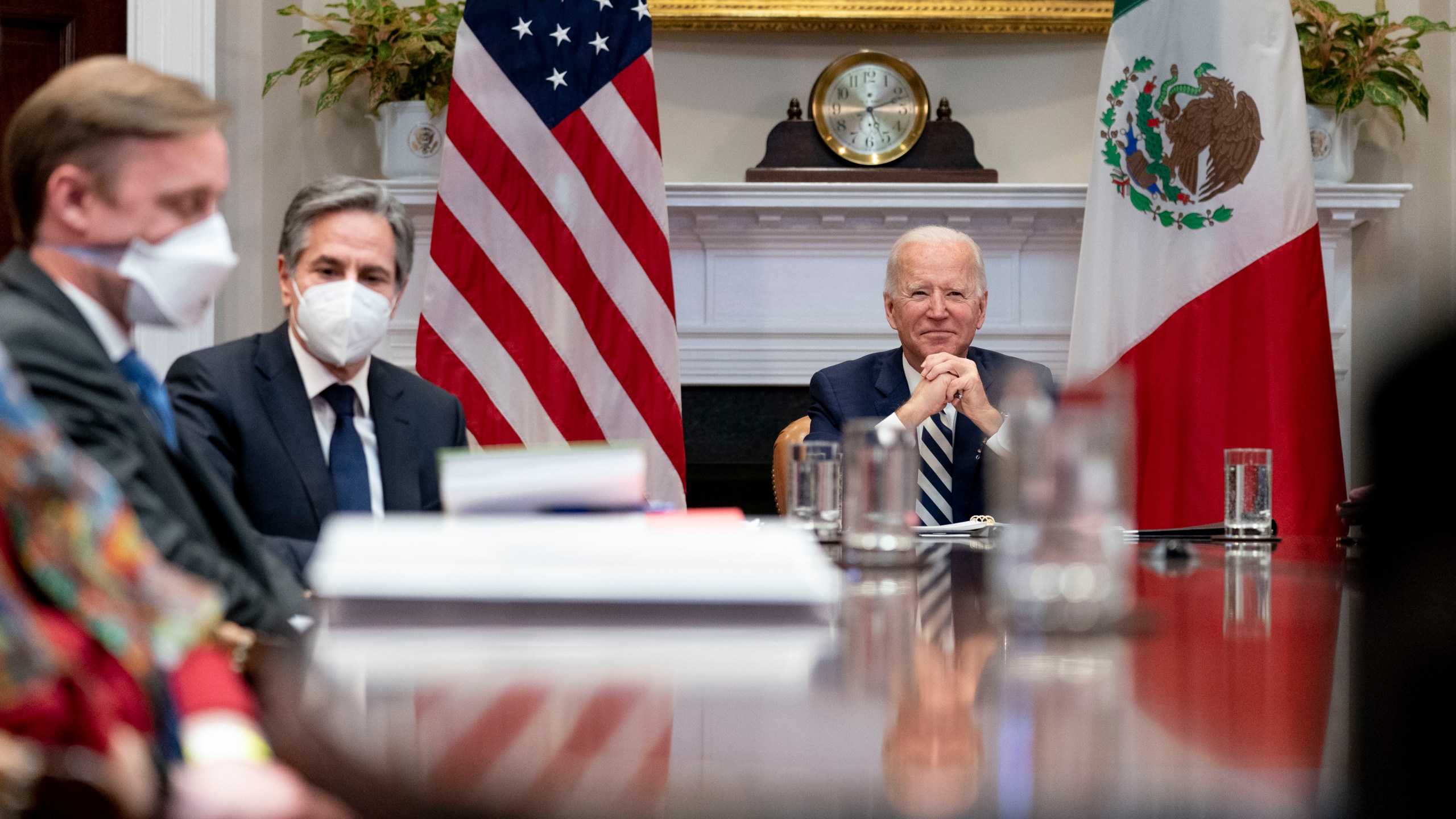 President Joe Biden, accompanied by White House national security adviser Jake Sullivan, left, and Secretary of State Antony Blinken, second from left, attends a virtual meeting with Mexican President Andres Manuel Lopez Obrador, in the Roosevelt Room of the White House, Monday, March 1, 2021, in Washington. (AP Photo/Andrew Harnik)