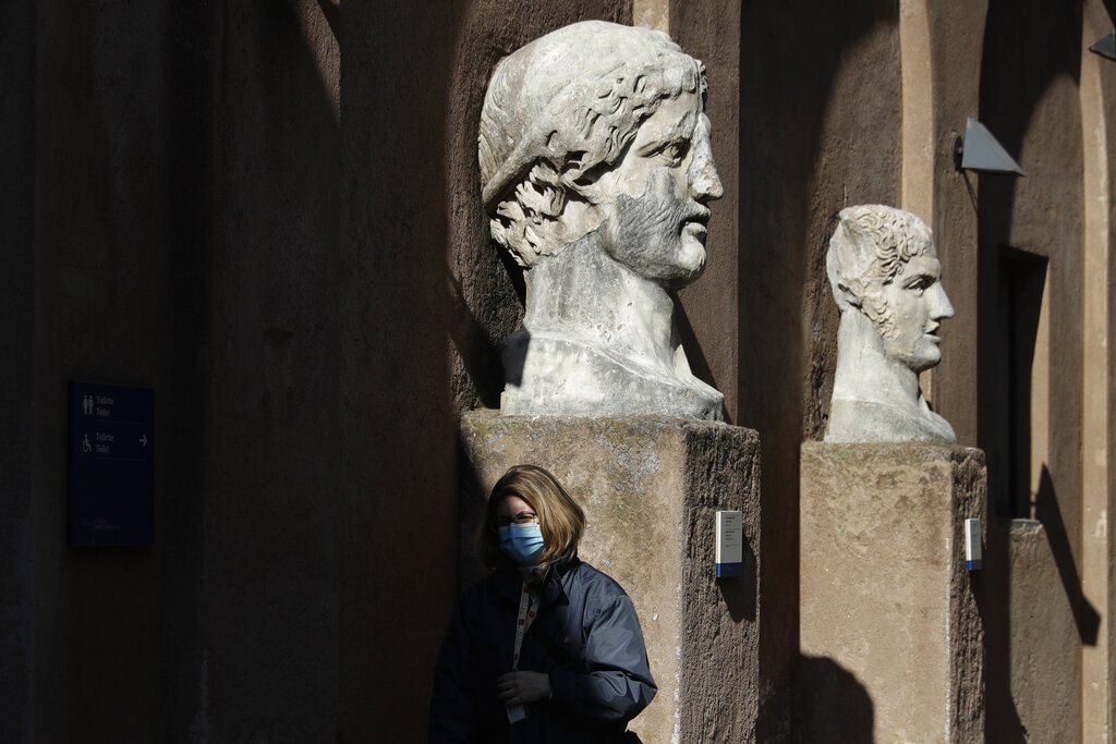 A museum usher stands by marble busts at the entrance of the Sant'Angelo castle In Rome Tuesday, March 2, 2021. (AP Photo/Gregorio Borgia)