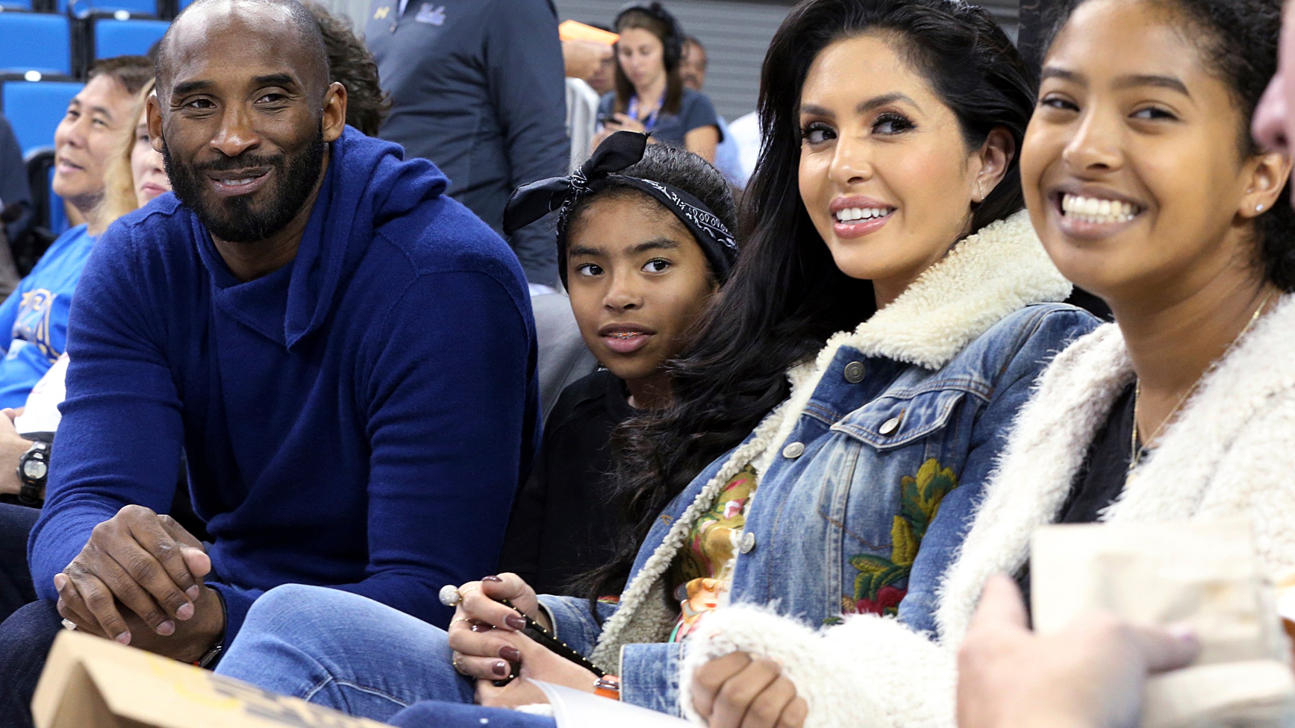 In this Nov. 21, 2017, file photo, from left, Los Angeles Lakers legend Kobe Bryant, his daughter Gianna Maria-Onore Bryant, wife Vanessa and daughter Natalia Diamante Bryant are seen before an NCAA college women's basketball game between Connecticut and UCLA, in Los Angeles. Vanessa Bryant says she is focused on “finding the light in darkness” in an emotional story in People magazine. She details how she attempts to push forward after her husband, Kobe Bryant, and daughter Gigi died in a helicopter crash in early 2020. (AP Photo/Reed Saxon, File)