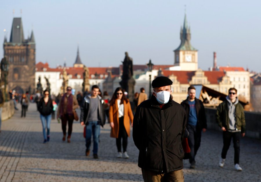 In this Thursday, Feb. 25, 2021 file photo, a man wearing a face mask walks across the medieval Charles Bridge in Prague, Czech Republic. (AP Photo/Petr David Josek, File)