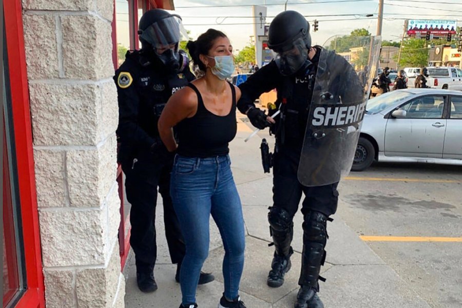 Police officers are shown arresting Des Moines Register reporter Andrea Sahouri after a Black Lives Matter protest she was covering on May 31, 2020, in Des Moines, Iowa, (Photo courtesy Katie Akin via AP)