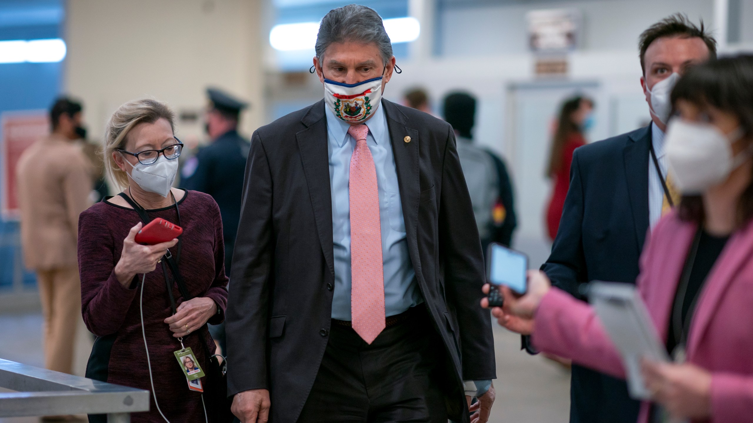 In this Feb. 25, 2021, file photo, reporters question Sen. Joe Manchin, D-W.Va., as he arrives for votes on President Joe Biden's cabinet nominees, at the Capitol in Washington. (AP Photo/J. Scott Applewhite, File)