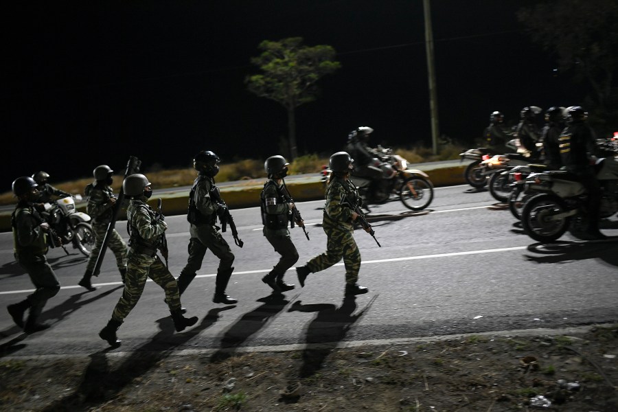 Security forces take part in a military drill to mark the eighth death anniversary of President Hugo Chavez in Caracas, Venezuela on March 5, 2021. (Matias Delacroix/Associated Press)