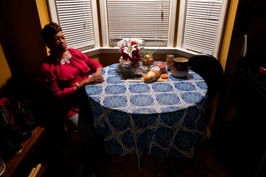 Karla Jefferies sits in her kitchen in Detroit, Friday, March 5, 2021. Jefferies, 64, a retired state worker in Detroit, Michigan, tested positive for COVID-19 in March 2020 and has been bothered by puzzling symptoms ever since. First it was fatigue, fever, and no taste or smell. Then came brain fog, insomnia, a nagging smell of something burning that only recently disappeared, and intermittent ringing in her ears. Now she can't hear out of her left ear. (AP Photo/Paul Sancya)