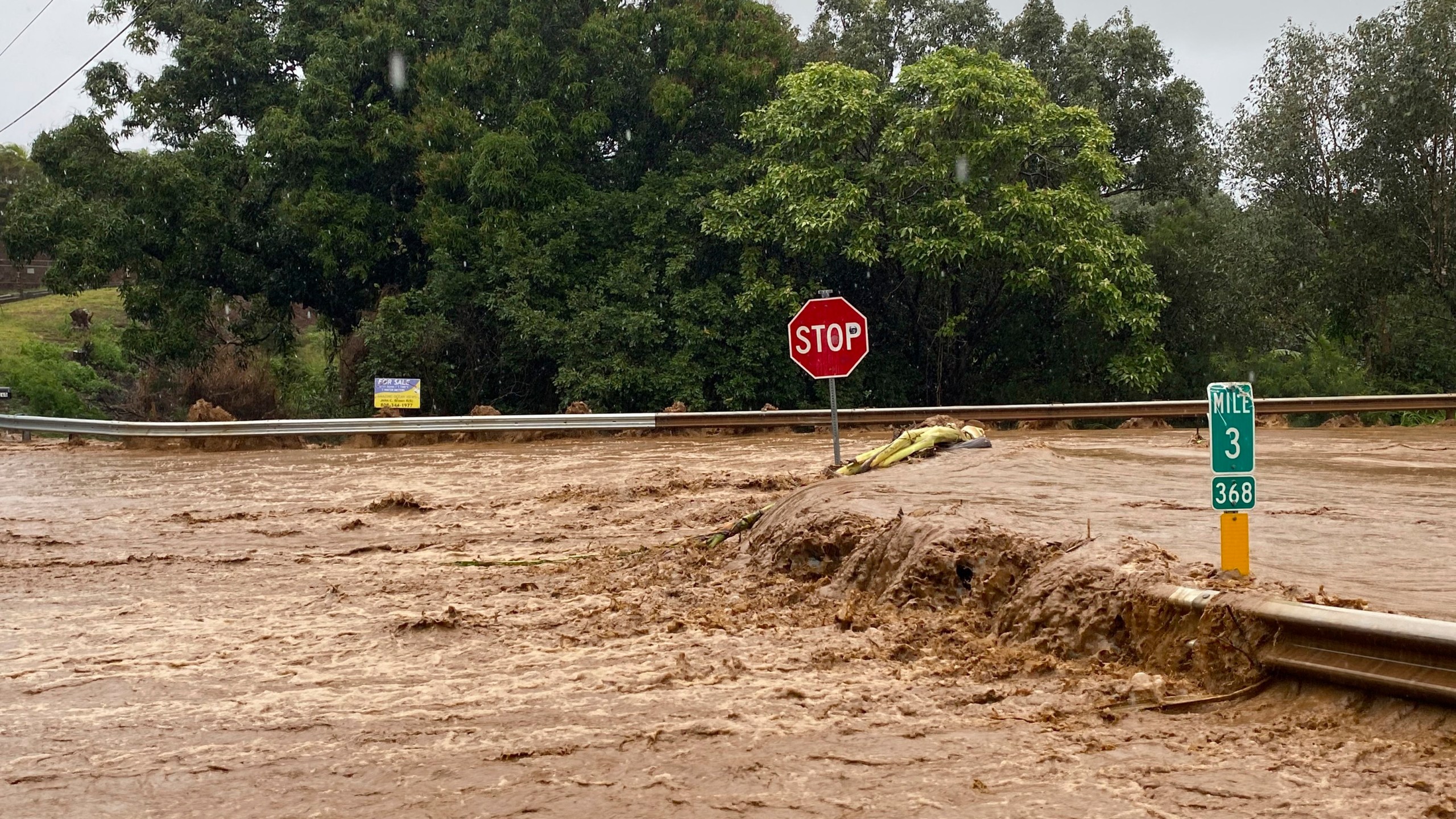 Floodwaters sweep over Hana Highway near West Kuiaha Road in Haiku, Maui, Hawaii, on Monday, March 8, 2021. (Kehaulani Cerizo/The Maui News via AP)