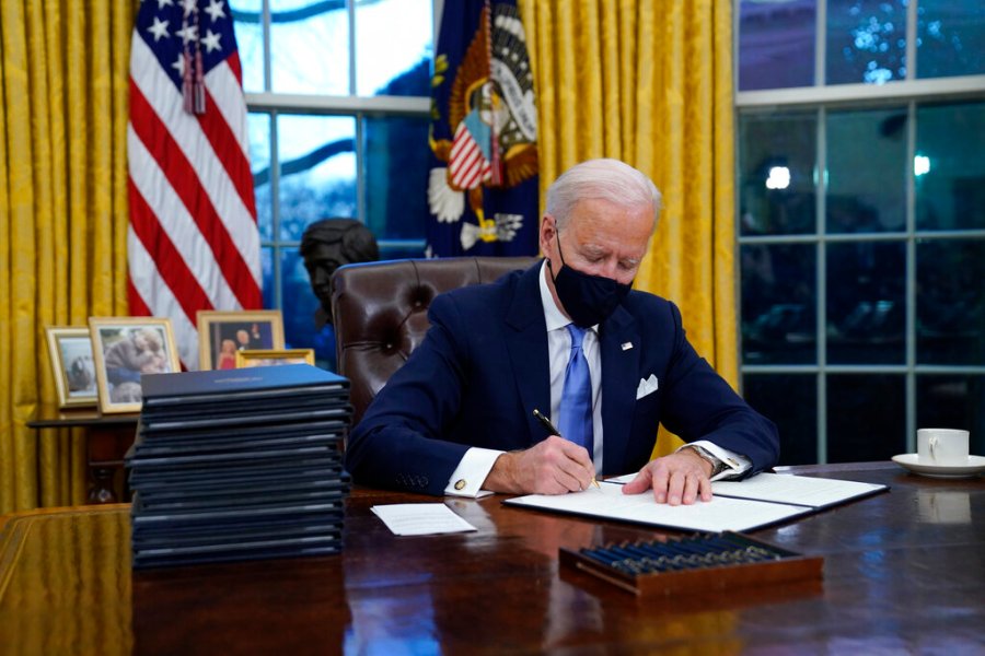 In this Jan. 20, 2021, file photo, President Joe Biden signs his first executive order in the Oval Office of the White House in Washington. (AP Photo/Evan Vucci, File)