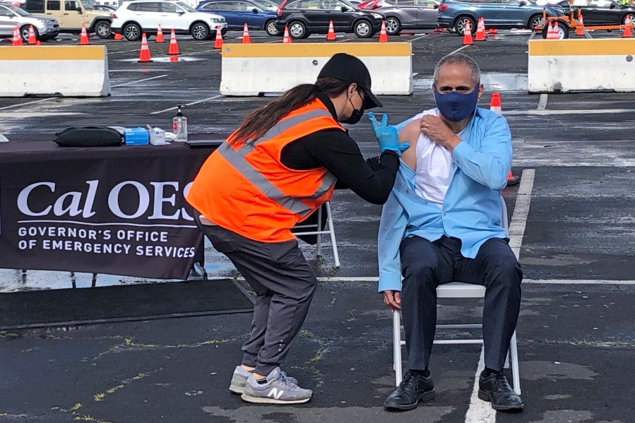 Dr. Tomas Aragon, State Public Health Officer and California Department of Public Health Director, takes part in a vaccination event at the RingCentral Coliseum in Oakland, Calif., on Thursday, March 11, 2021, to highlight the new one-dose Janssen COVID-19 vaccine by Johnson & Johnson. (AP Photo/Haven Daley)