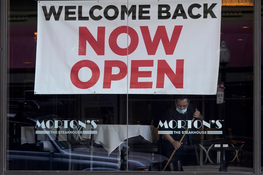 In this March 4, 2021, file photo, a sign reading "Welcome Back Now Open" is posted on the window of a Morton's Steakhouse restaurant as a man works inside during the coronavirus pandemic in San Francisco. (AP Photo/Jeff Chiu, File)In this March 4, 2021, file photo, a sign reading "Welcome Back Now Open" is posted on the window of a Morton's Steakhouse restaurant as a man works inside during the coronavirus pandemic in San Francisco. (AP Photo/Jeff Chiu, File)