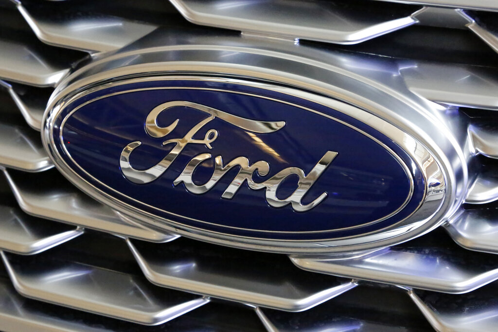 This Feb. 15, 2018, file photo shows a Ford logo on the grill of a 2018 Ford Explorer on display at the Pittsburgh Auto Show. (AP Photo/Gene J. Puskar, File)