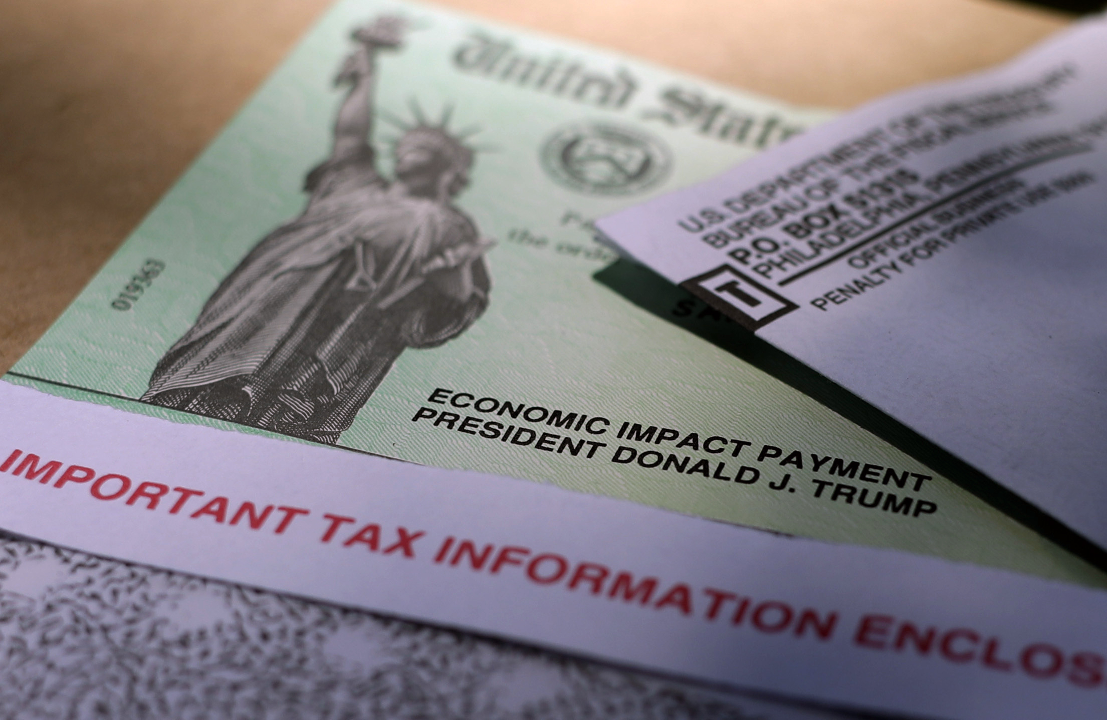 In this April 23, 2020 file photo, President Donald J. Trump's name is printed on a stimulus check issued by the IRS to help combat the adverse economic effects of the COVID-19 outbreak in San Antonio. Officials at the Treasury Department and Internal Revenue Service said Friday, March 12, 2021 that processing the new round of stimulus payments has already begun, with the aim of having the first payments start showing up in bank accounts this weekend. (AP Photo/Eric Gay, File)