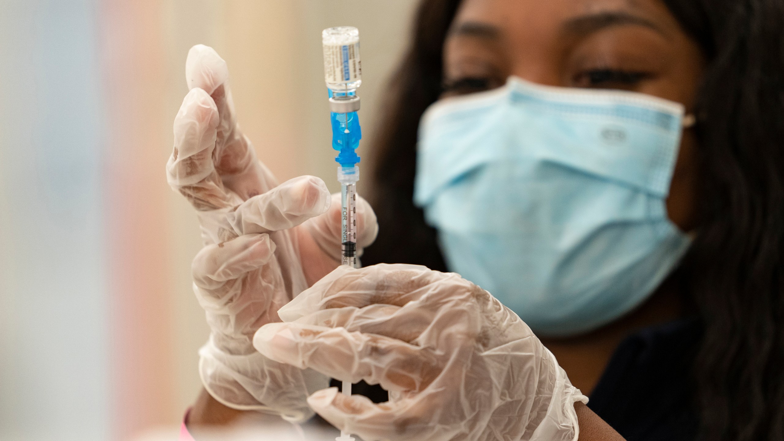 In this Thursday, March 11, 2021, file photo, a health worker loads syringes with the vaccine on the first day of the Johnson & Johnson vaccine being made available to residents at the Baldwin Hills Crenshaw Plaza in Los Angeles. (AP Photo/Damian Dovarganes, File)