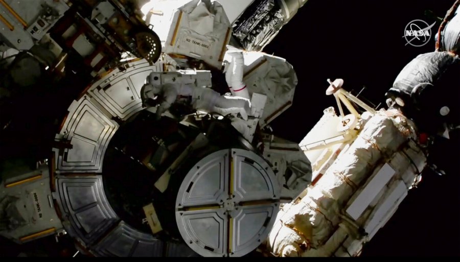 In this image provided by NASA shows NASA astronauts Victor Glover and Mike Hopkins on a spacewalk outside the International Space Station on Saturday, March 13, 2021. (NASA via AP)