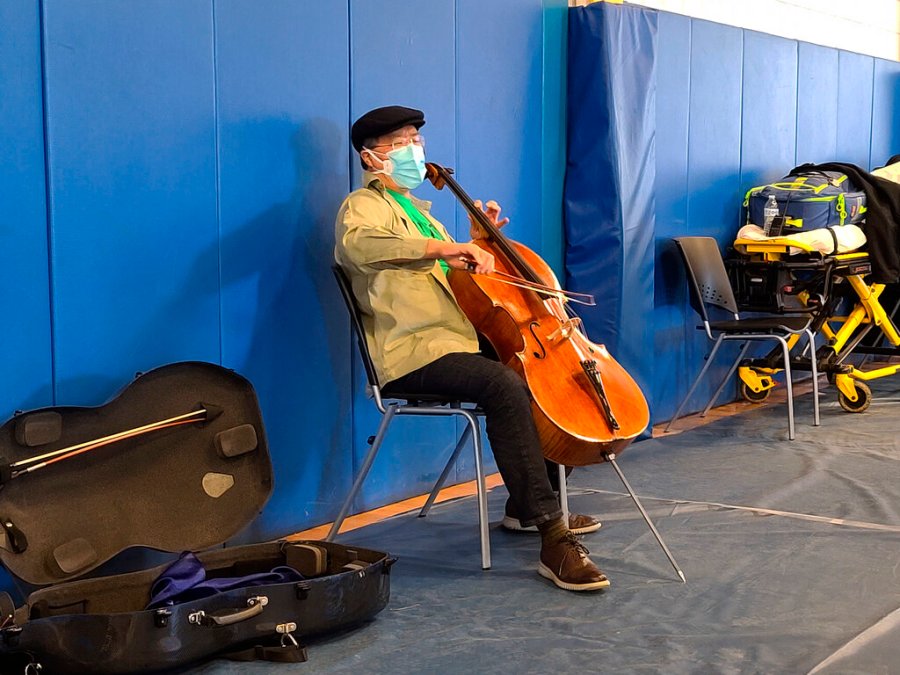 This photo provided by Berkshire Community College shows cellist Yo-Yo Ma performing at Berkshire Community College’s second dose Pfizer vaccination clinic in the Paterson Field House on Saturday, March 13, 2021 in Pittsfield, Mass. (Jonah Sykes/Berkshire Community College via AP)