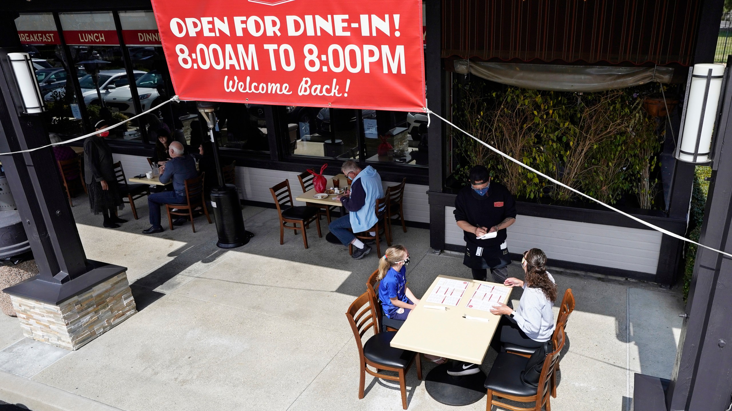 Diners Evie Costello, left, and Mandissa Costello, right, are served by Isaac Villaneva at Agoura's Famous Deli Sunday, March 14, 2021, in the Agoura Hills section of Los Angeles County. (AP Photo/Mark J. Terrill)Diners Evie Costello, left, and Mandissa Costello, right, are served by Isaac Villaneva at Agoura's Famous Deli Sunday, March 14, 2021, in the Agoura Hills section of Los Angeles County. (AP Photo/Mark J. Terrill)