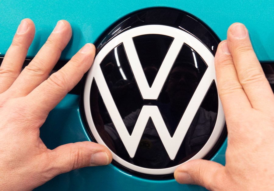 In this Feb. 25, 2020, file photo, a worker completes an electric car ID.3 body at the assembly line during a press tour at the plant of the German manufacturer Volkswagen AG (VW) in Zwickau, eastern Germany. (AP Photo/Jens Meyer, file)