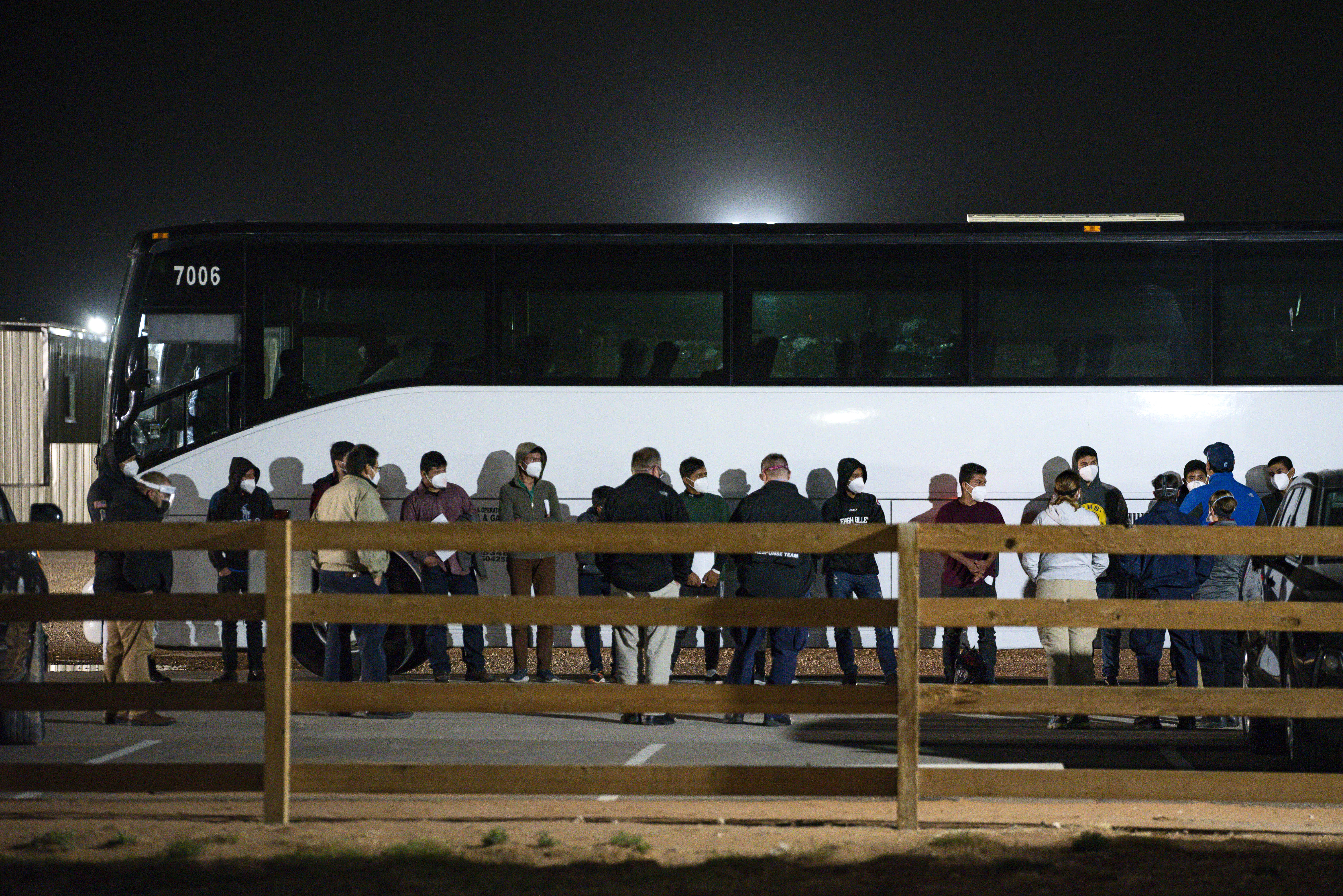 In this Sunday, March 14, 2021, file photo, migrant children and teenagers are processed after entering the site of a temporary holding facility south of Midland, Texas. Teenagers began arriving Sunday at a converted camp for oilfield workers where volunteers from the American Red Cross will care for them. (Eli Hartman/Odessa American via AP, File)