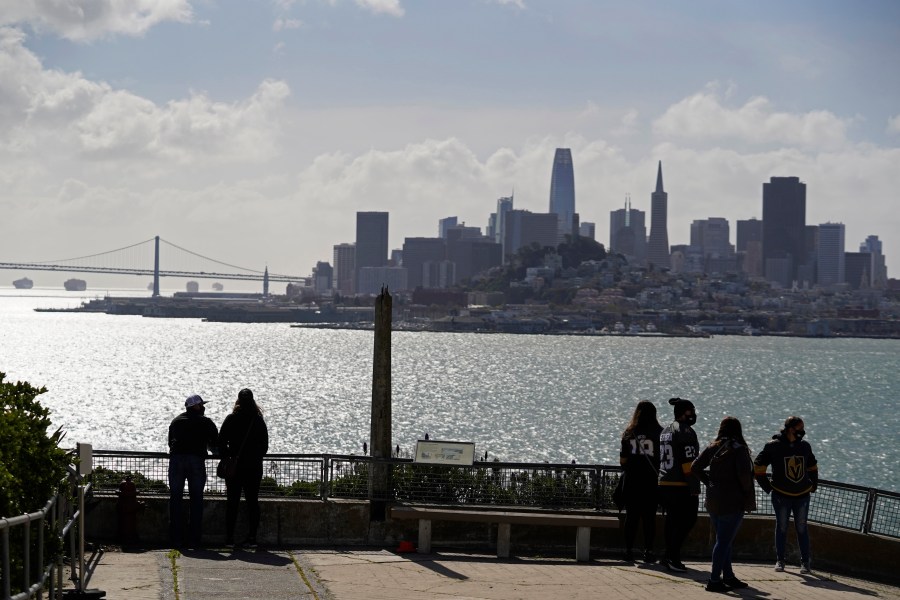 People look out at the views of the skyline and bay from Alcatraz Island in San Francisco, Monday, March 15, 2021. (AP Photo/Eric Risberg)