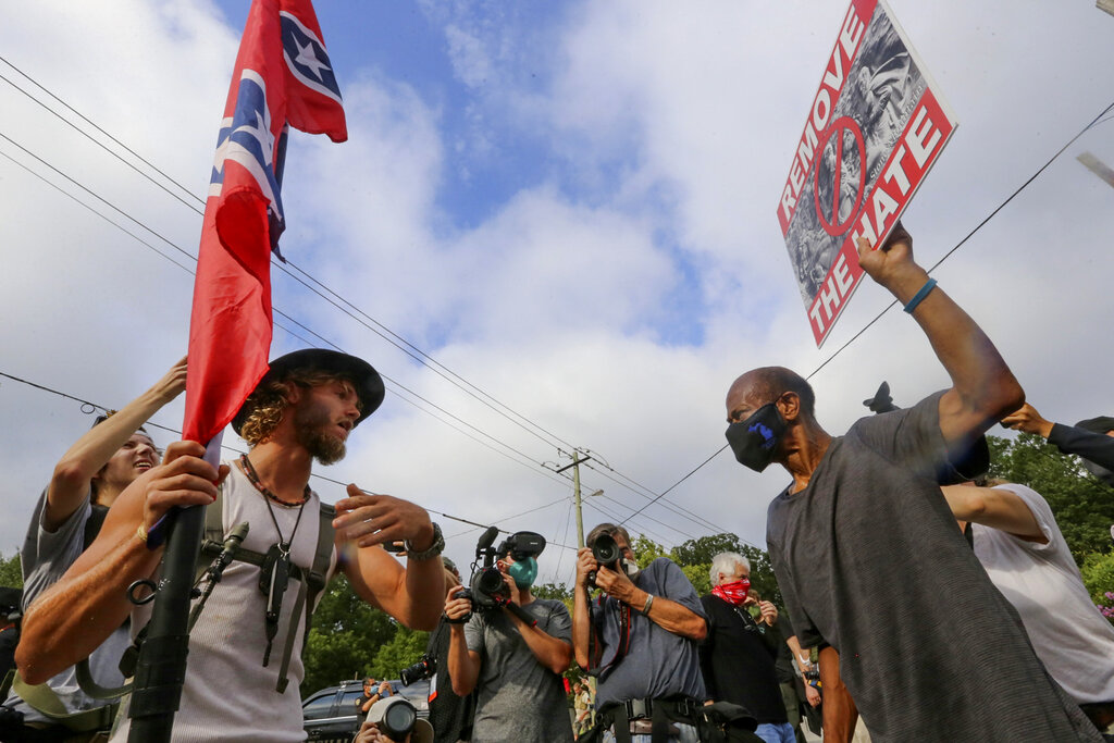 In this Aug. 15, 2020, file photo, protesters and counterprotesters face off in Stone Mountain Village, Ga. (Jenni Girtman/Atlanta Journal-Constitution via AP, File)