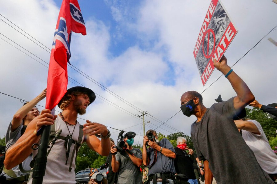 In this Aug. 15, 2020, file photo, protesters and counterprotesters face off in Stone Mountain Village, Ga. (Jenni Girtman/Atlanta Journal-Constitution via AP, File)