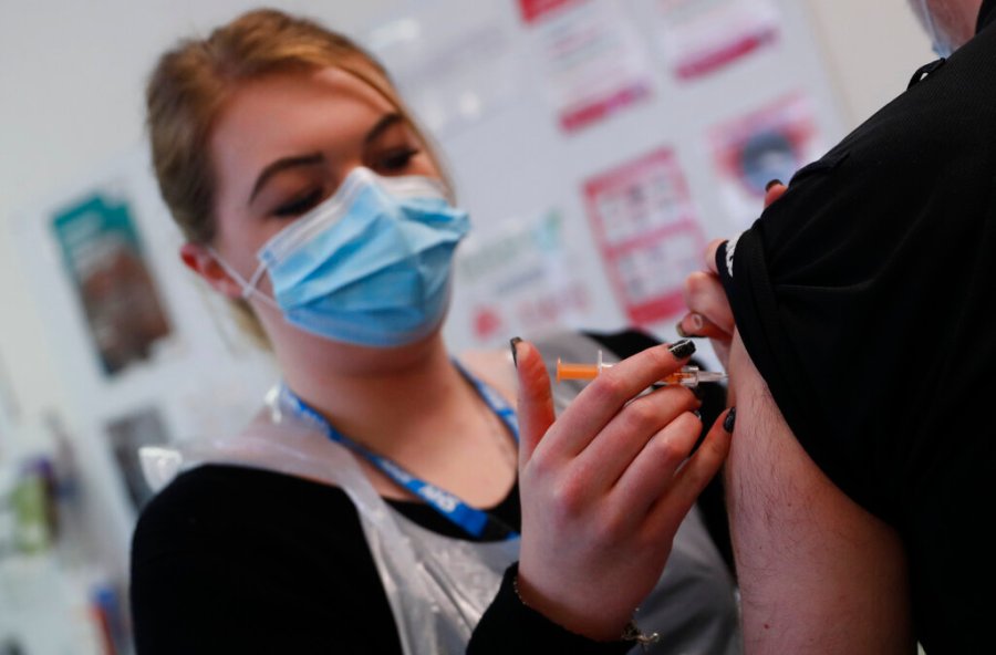 Pharmacy Technician Katrina Bonwick administers a dose of the AstraZeneca COVID-19 vaccine at the Wheatfield surgery in Luton, England, Thursday, March 18, 2021. (AP Photo/Alastair Grant)