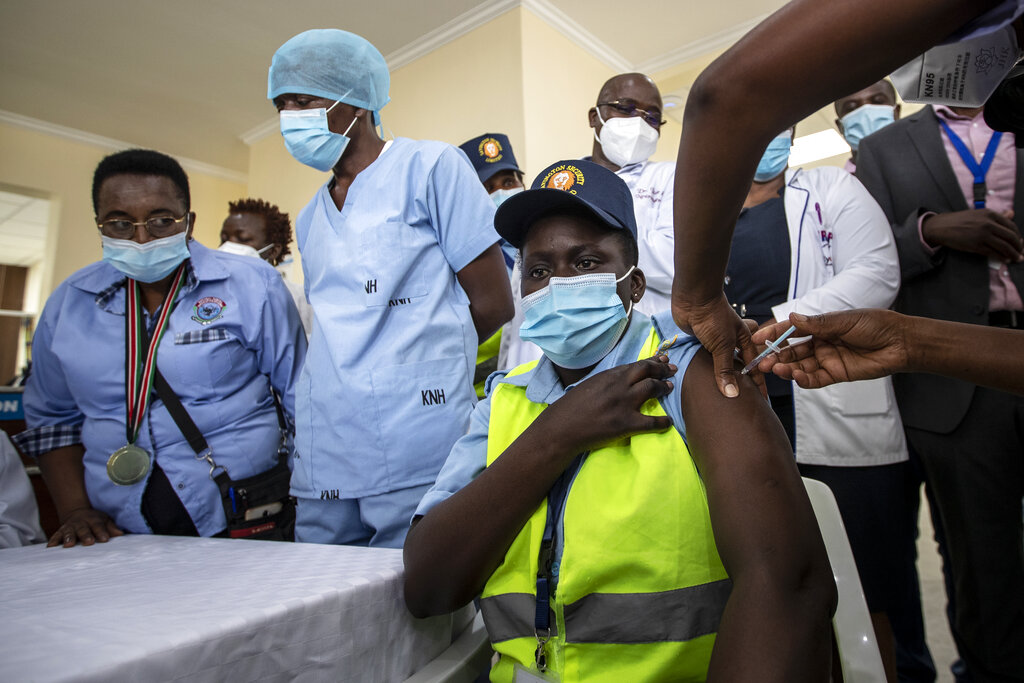 In this March 5, 2021, file photo, a hospital security guard receives one of the country's first coronavirus vaccinations using AstraZeneca COVID-19 vaccine provided through the global COVAX initiative, at Kenyatta National Hospital in Nairobi, Kenya. (AP Photo/Ben Curtis, File)