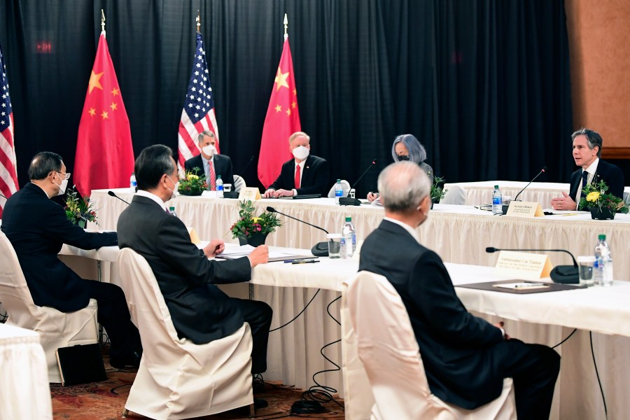 Secretary of State Antony Blinken, speaks as Chinese Communist Party foreign affairs chief Yang Jiechi, left, and China's State Councilor Wang Yi, second from left, listen at the opening session of US-China talks at the Captain Cook Hotel in Anchorage, Alaska, Thursday, March 18, 2021. (Frederic J. Brown/Pool via AP)