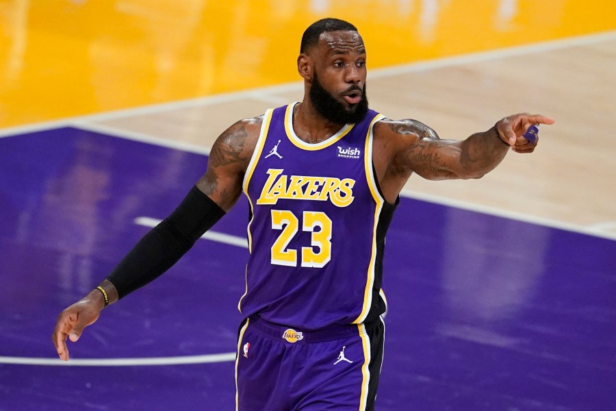 Los Angeles Lakers forward LeBron James signals to a teammate during the first half of an NBA basketball game against the Charlotte Hornets on Thursday, March 18, 2021, in Los Angeles. (AP Photo/Marcio Jose Sanchez)