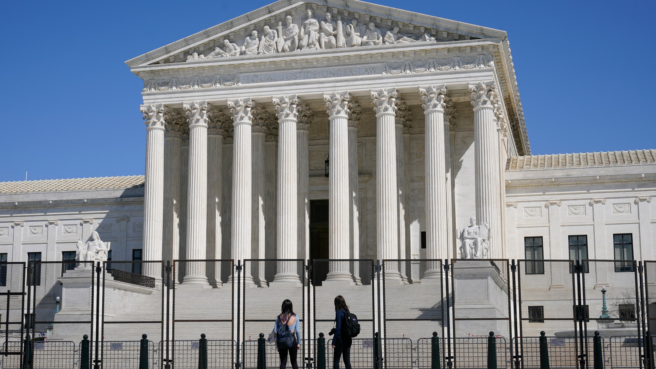 People view the Supreme Court building from behind security fencing on March 21, 2021. (Patrick Semansky/Associated Press)