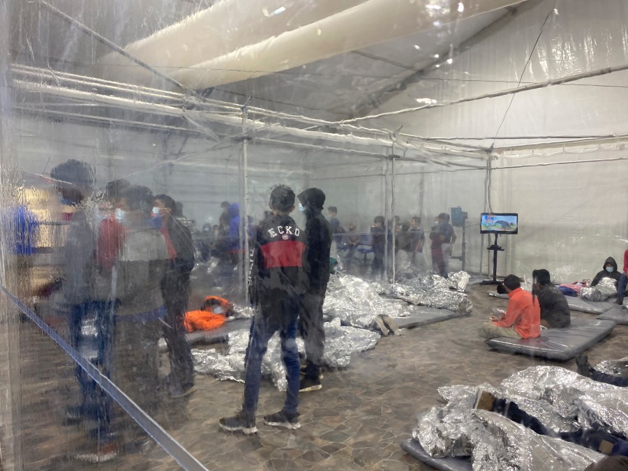 This March 20, 2021 photo provided by the Office of Congressman Henry Cuellar, (TX-28), shows detainees in a Customs and Border Protection (CBP) temporary overflow facility in Donna, Texas. President Joe Biden's administration faces mounting criticism for refusing to allow outside observers into facilities where it is detaining thousands of immigrant children. (Photo courtesy of the Office of Congressman Henry Cuellar via AP)