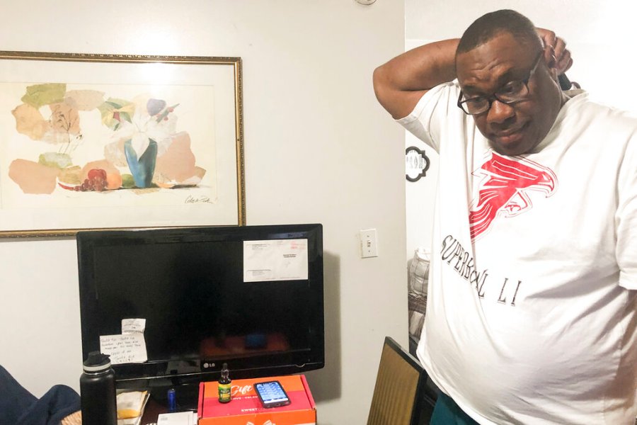 Armetrius Neason poses for a photo inside his room at the Efficiency Lodge hotel outside Atlanta on March 16, 2021. (AP Photo/Sudhin S. Thanawala)