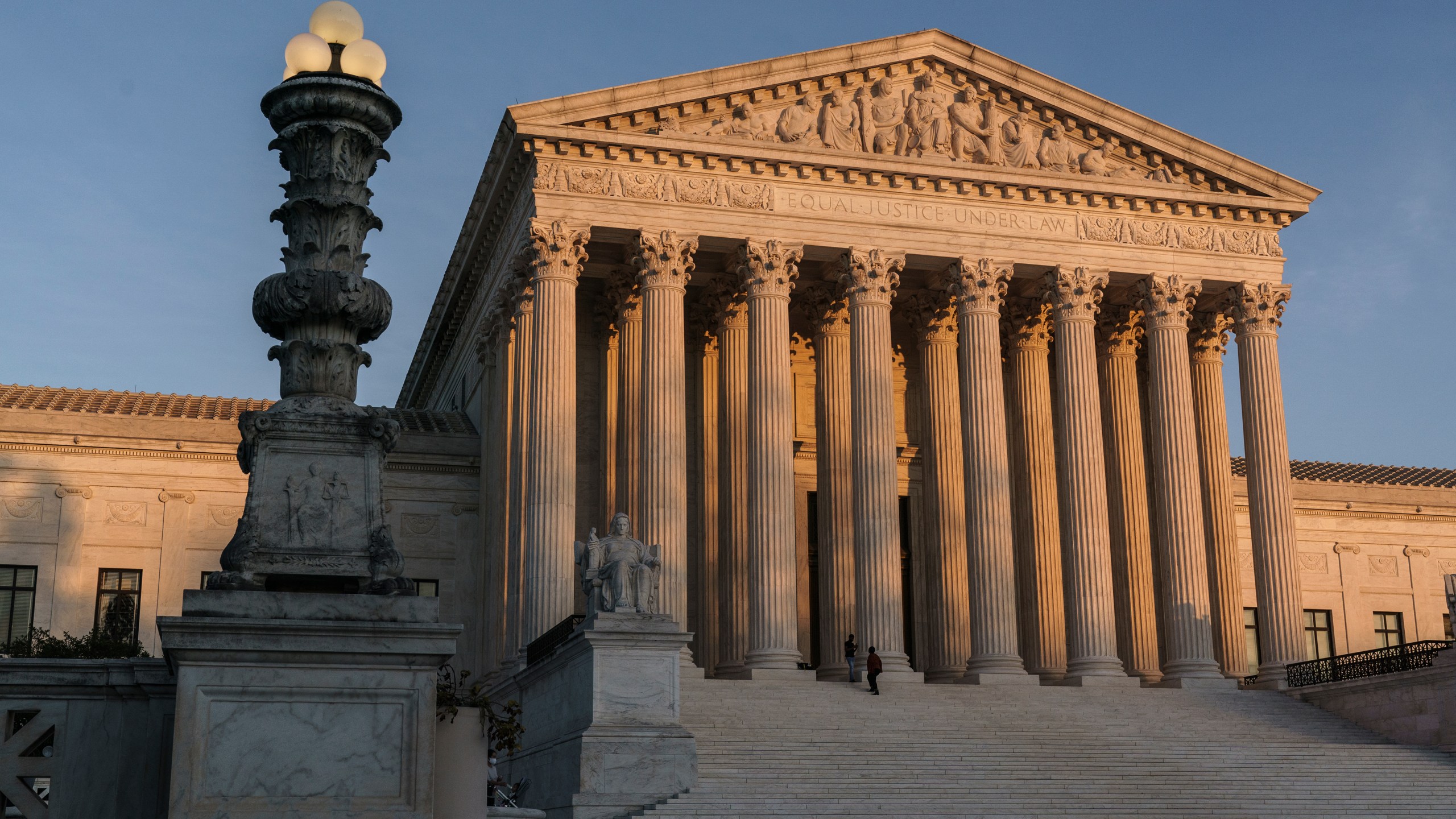 In this Nov. 6, 2020, file photo, the Supreme Court is seen at sundown in Washington. The Supreme Court appears ready to side with two California agriculture businesses that want to bar labor organizers from their property. (AP Photo/J. Scott Applewhite, File)