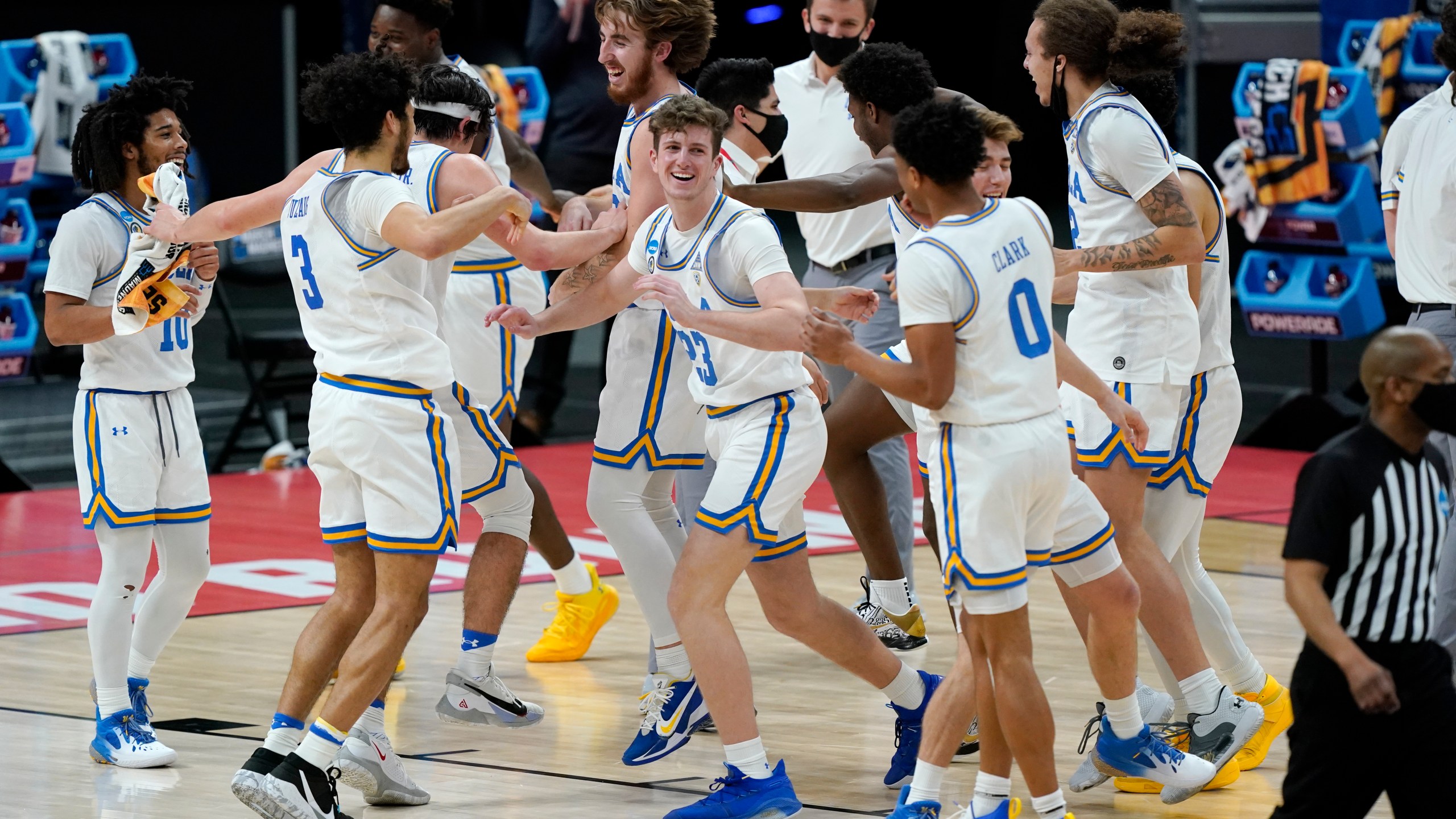 UCLA players celebrate their win over Abilene Christian in a college basketball game in the second round of the NCAA tournament at Bankers Life Fieldhouse in Indianapolis on March 22, 2021. (Mark Humphrey / Associated Press)