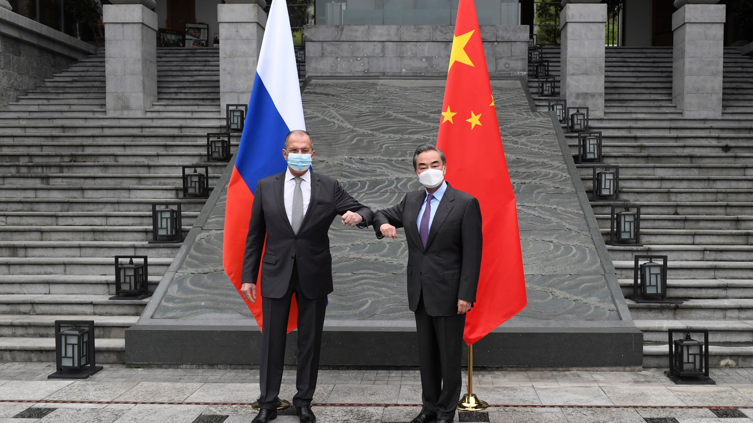 In this photo released by China's Xinhua News Agency, Russian Foreign Minister Sergei Lavrov, left, meets with Chinese Foreign Minister Wang Yi in Guilin in southern China's Guangxi Zhuang Autonomous Region, Monday, March 22, 2021. (Lu Boan/Xinhua via AP)