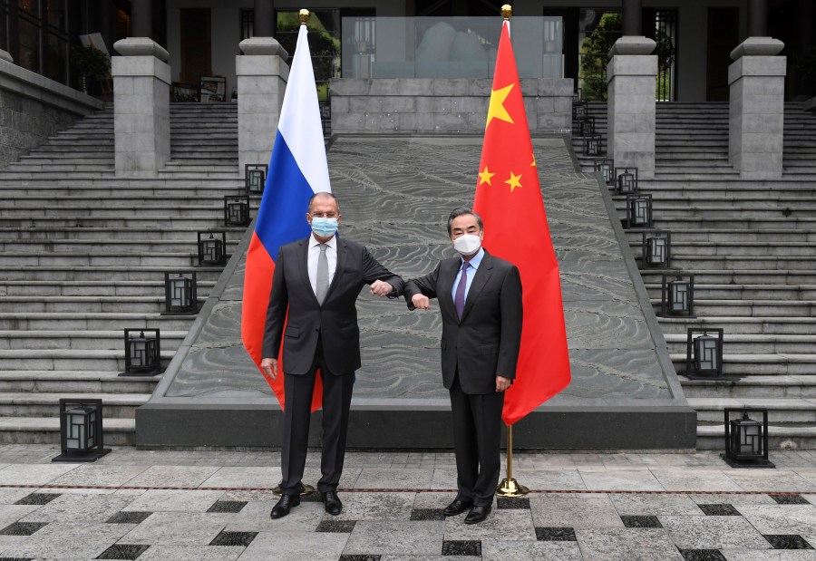 In this photo released by China's Xinhua News Agency, Russian Foreign Minister Sergei Lavrov, left, meets with Chinese Foreign Minister Wang Yi in Guilin in southern China's Guangxi Zhuang Autonomous Region, Monday, March 22, 2021. (Lu Boan/Xinhua via AP)