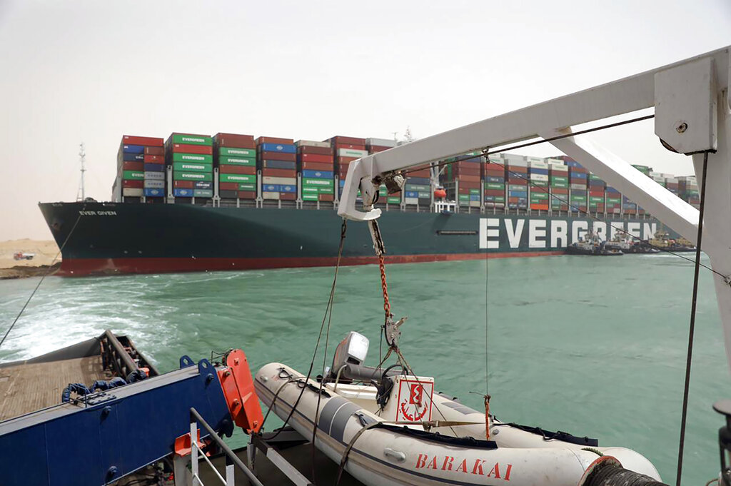 This photo released by the Suez Canal Authority on Thursday, March 25, 2021, shows the Ever Given, a Panama-flagged cargo ship, after it become wedged across the Suez Canal and blocking traffic in the vital waterway. (Suez Canal Authority via AP)