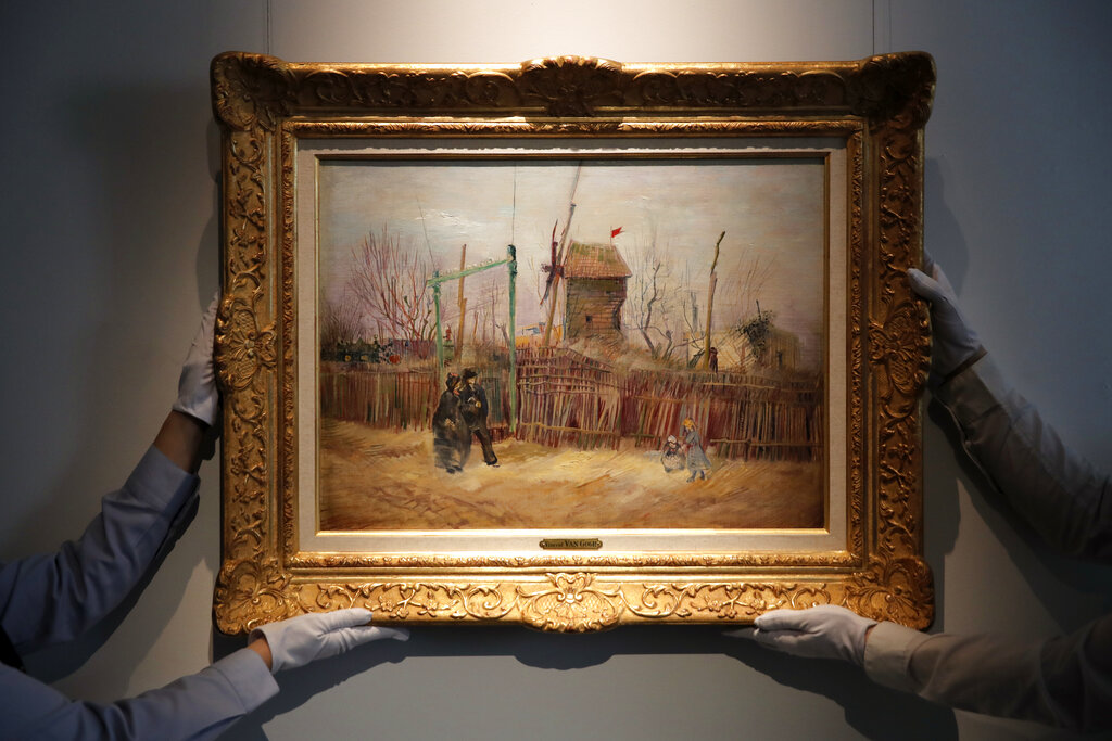 In this Feb. 25, 2021, file photo, Sotheby's personnel display (Street scene in Montmartre), a painting by Dutch master Vincent van Gogh at Sotheby's auction house in Paris. (AP Photo/Christophe Ena, File)