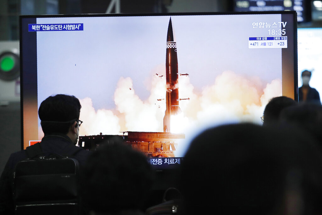 People watch a TV showing an image of North Korea's new guided missile during a news program at the Suseo Railway Station in Seoul, South Korea, Friday. March 26, 2021. (AP Photo/Ahn Young-joon)