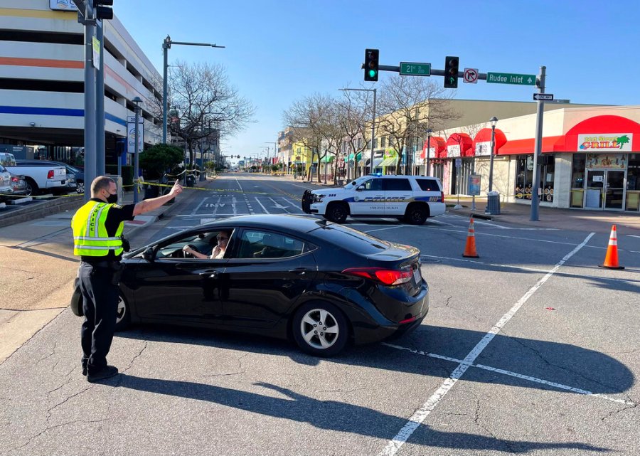 Virginia Beach police redirect traffic on March 27, 2021 after late night shootings as they investigate a late night shooting in Virginia Beach, Va. A pair of overnight fatal shootings along the beachfront in Virginia Beach wounded several people in a scene described by authorities on Saturday as “very chaotic.” (Stephen Katz/The Virginian-Pilot via AP)