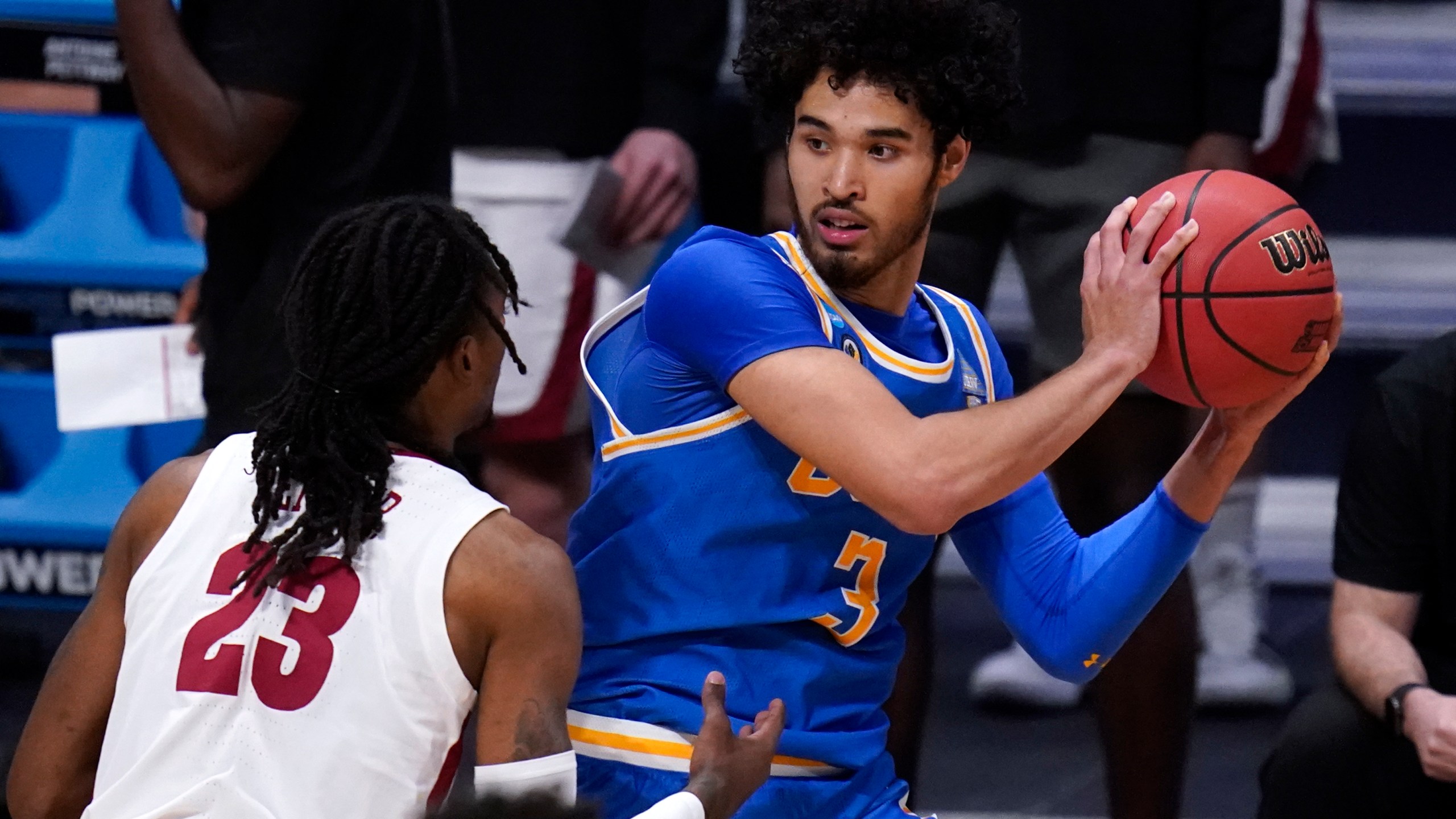 UCLA guard Johnny Juzang (3) protects the ball from Alabama guard John Petty Jr. (AP Photo/Michael Conroy)