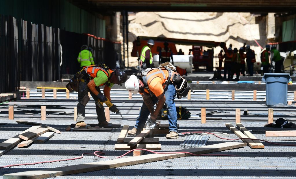 Construction workers in the Frenso Trench build a portion of the high-speed railway line on May 8, 2019. (FREDERIC J. BROWN / AFP / Getty Images)