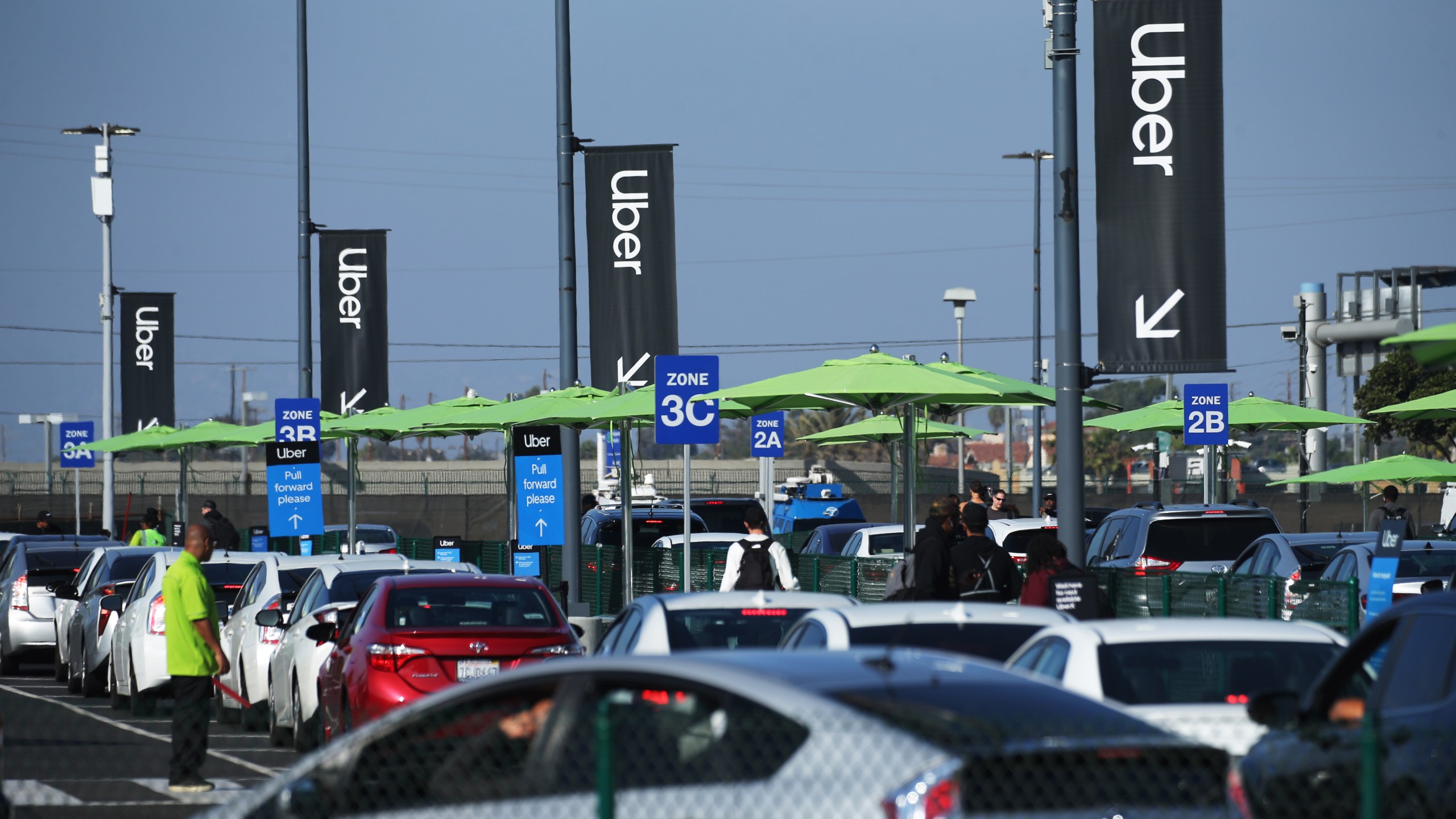 Uber vehicles are lined up at the 'LAX-it' ride-hail passenger pickup lot at Los Angeles International Airport on Nov. 6, 2019 in Los Angeles. (Mario Tama/Getty Images)