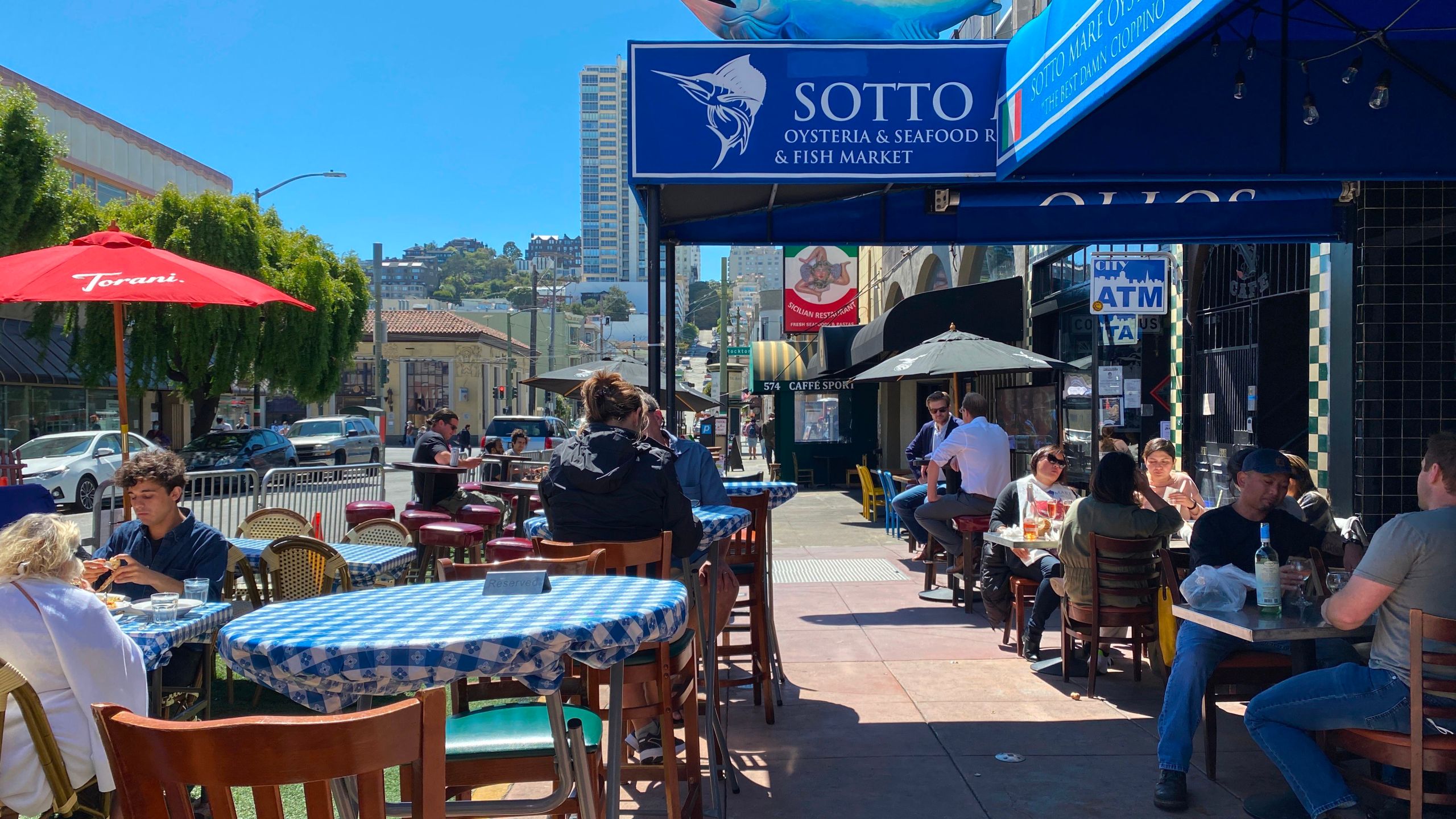 People enjoy socially distanced outdoor dining in the Little Italy neighborhood of San Francisco, Calif., on July 31, 2020. (Daniel SLIM / AFP via Getty Images)