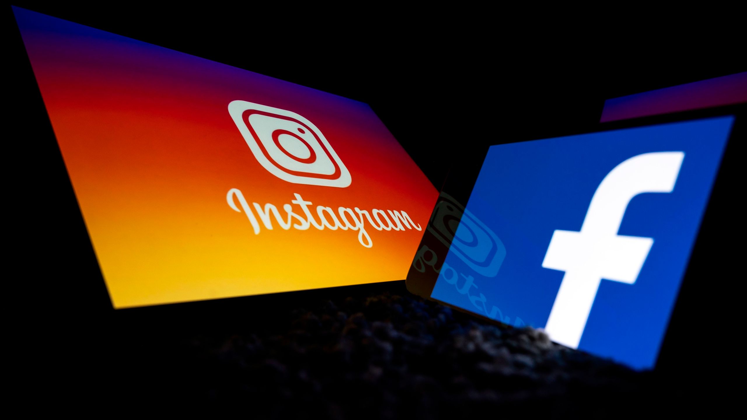 This picture taken on October 5, 2020 in Toulouse, southwestern France, shows logos of US social networks Facebook and Instagram on the screens of a tablet and a mobile phone. (Lionel Bonaventure/AFP via Getty Images)